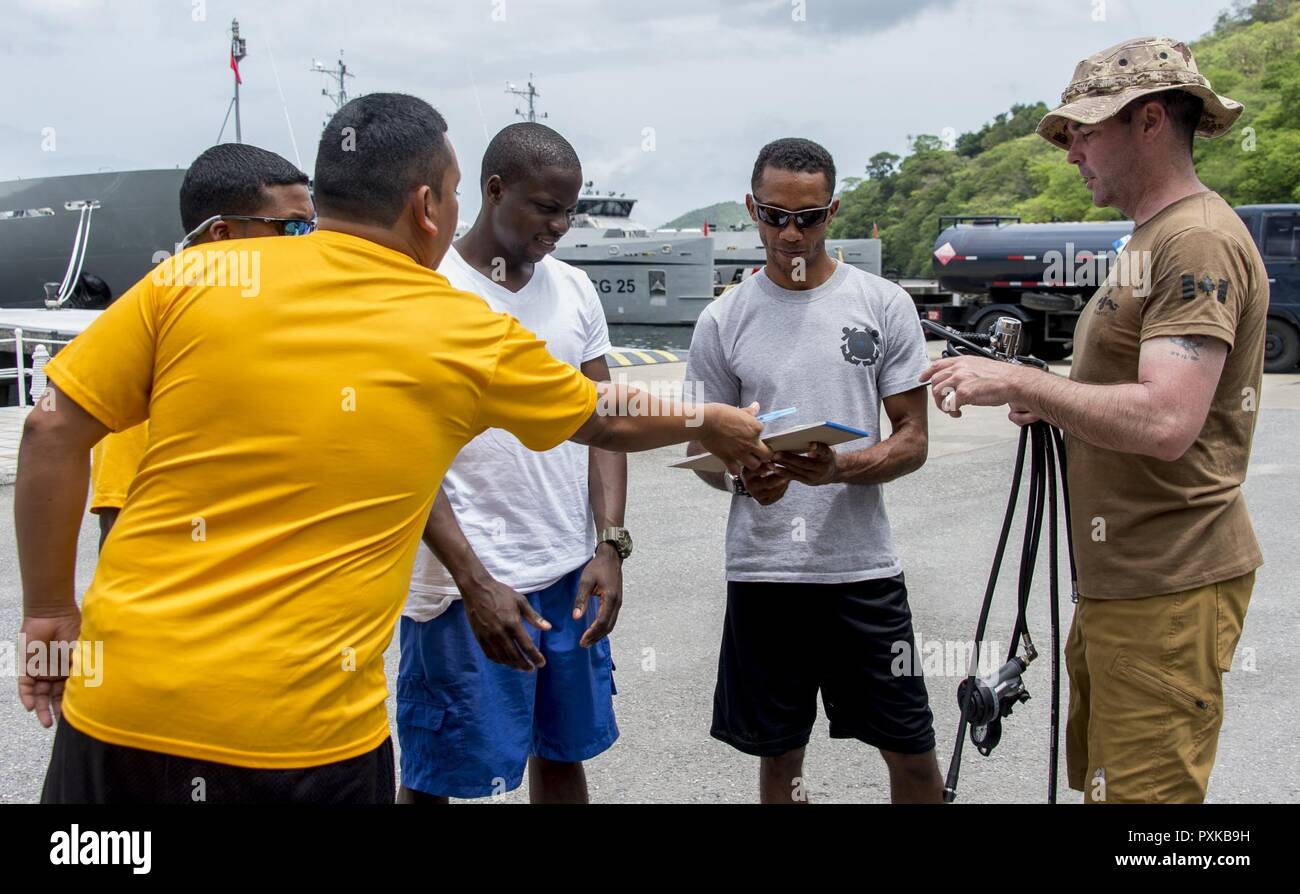 PORT OF SPAIN, Trinidad - Master Seaman Quinn Audette, clearance diver from Fleet Diving Unit Atlantic, distributes regulators to participating divers from Belize, Mexico, Bahamas and Jamaica, during Exercise TRADEWINDS 17, in Chaguaramas, Trinidad and Tobago on June 1, 2017. (Canadian Forces Combat Camera Stock Photo