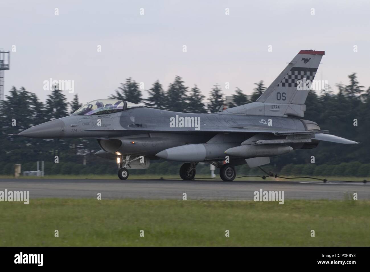 An F-16 Fighting falcon assigned to the 36th Fighter Squadron, Osan Air Base, engages a barrier during an annual certification test of the Aircraft Arresting System at Yokota Air Base, Japan, June 1, 2017. Airmen from the 374 CES and 374th Operations Support Squadron are responsible for setting up the system and logging any deficiencies during the test. Stock Photo