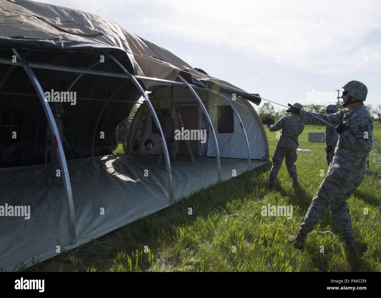 Airmen from the 5th Civil Engineer Squadron build a tent at Minot Air