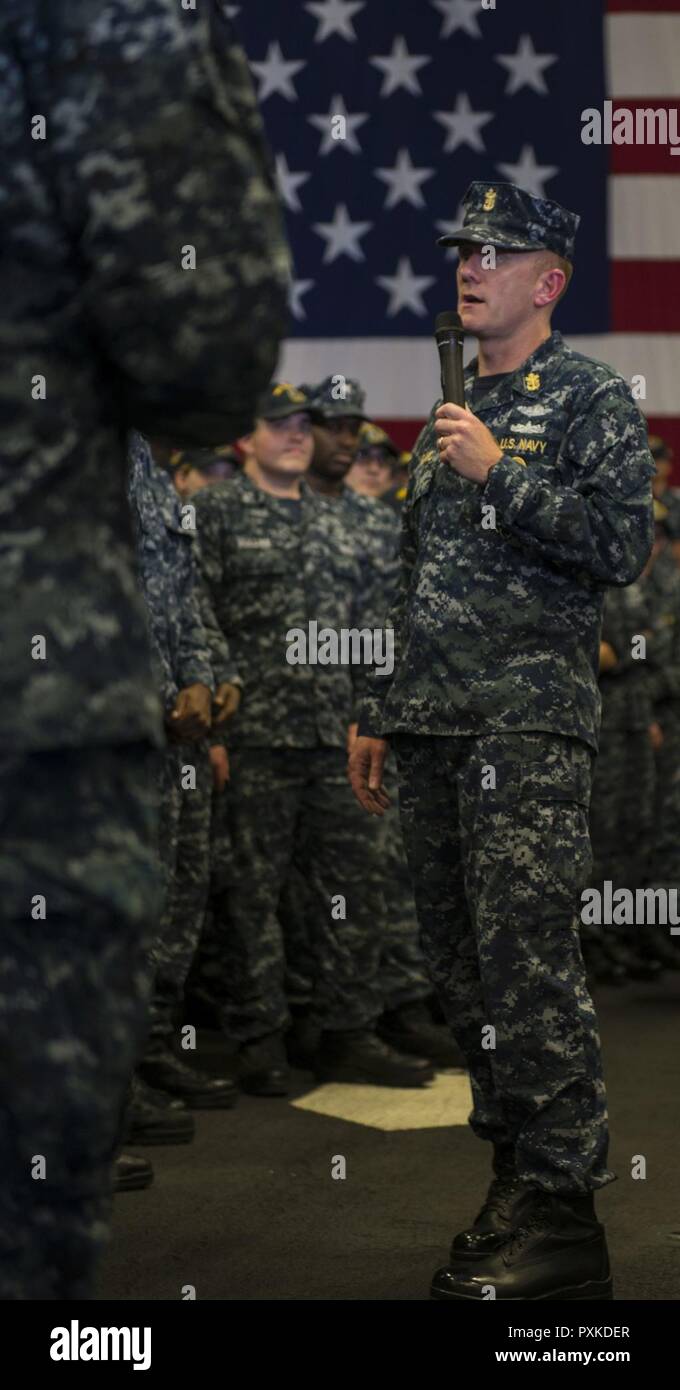 MAYPORT, Fla. (June 7, 2017) Master Chief Petty Officer of the Navy (MCPON) Steven S. Giordano addresses the crew of the amphibious assault ship USS Iwo Jima (LHD 7) during an all-hands call in the ship's hangar bay. During the call, Giordano discussed the Navy’s retention efforts, Sailor 2025 initiatives and answered questions from the crew. Stock Photo