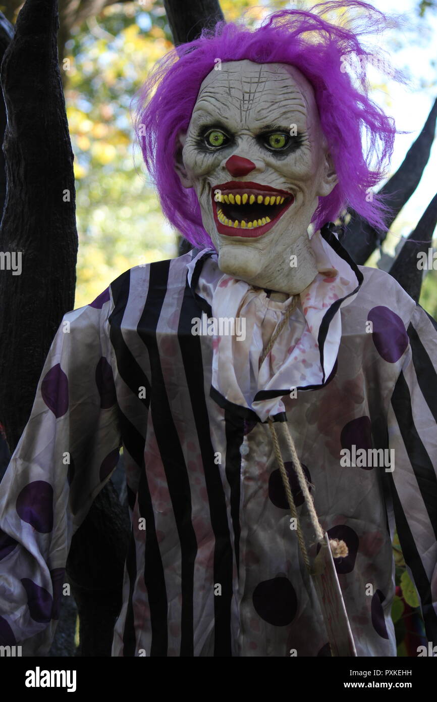 Super creepy, disturbing, and eerie Batman's joker as a Halloween decoration displayed on a front lawn. Stock Photo