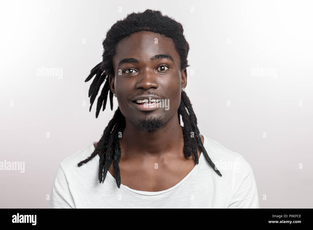 Happy Afro-American man smiling isolated on white studio background. African American male profile portrait Stock Photo