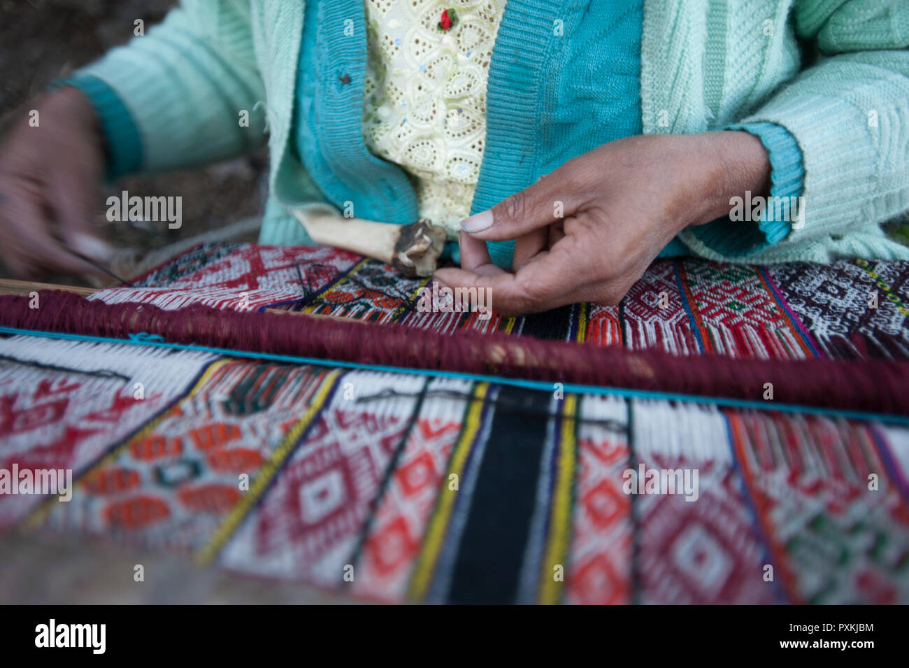 Along the Qapac-ñan in the area of Lares, many people live in small villages, the art of weaving is common among women of these communities. Stock Photo