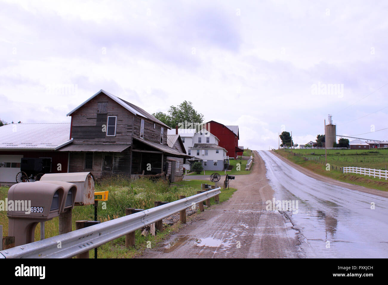 Wet road through Amish country on a cloudy morning in Berlin, Ohio Stock Photo