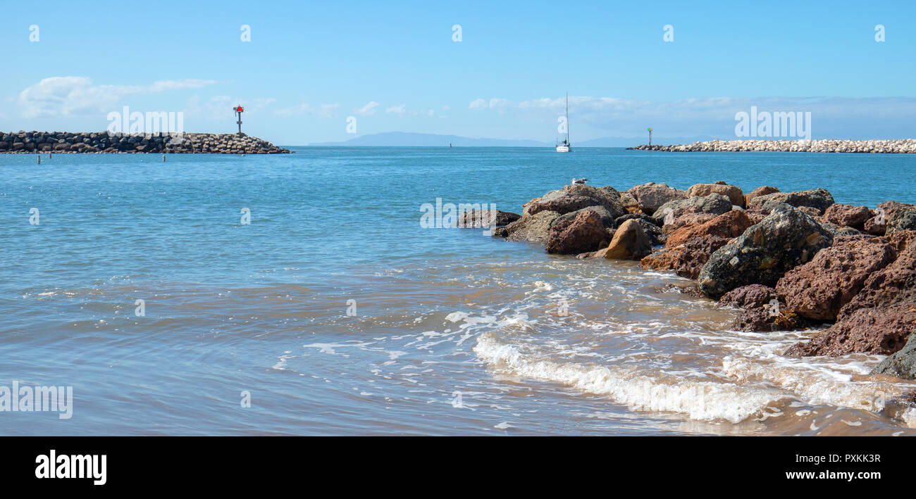 Ventura beach and sea rock wall jetty on the California coastline USA Stock Photo