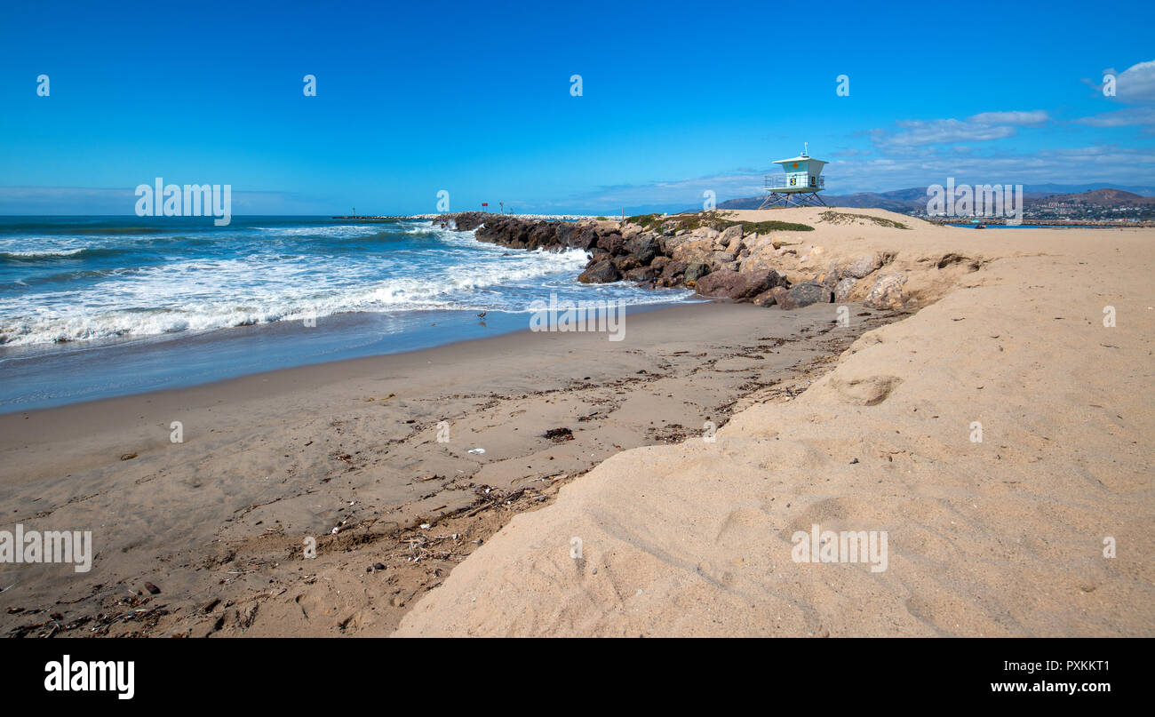 Lifeguard tower and rock jetty seawall in Ventura California United States Stock Photo