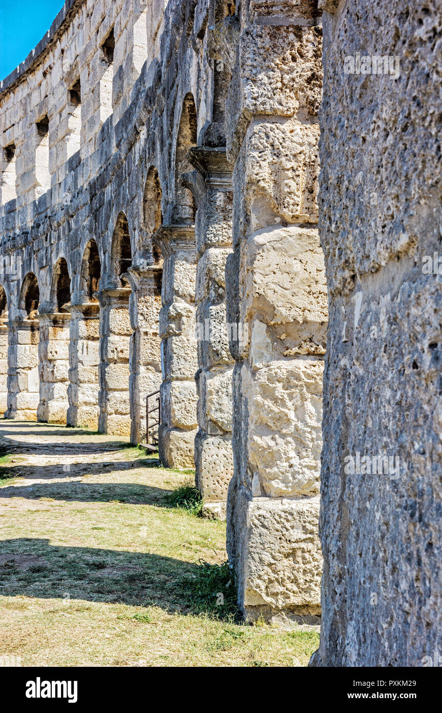 Detail photo of Pula Arena, Istria, Croatia. Travel destination. Ancient architecture. Vertical composition. Stock Photo