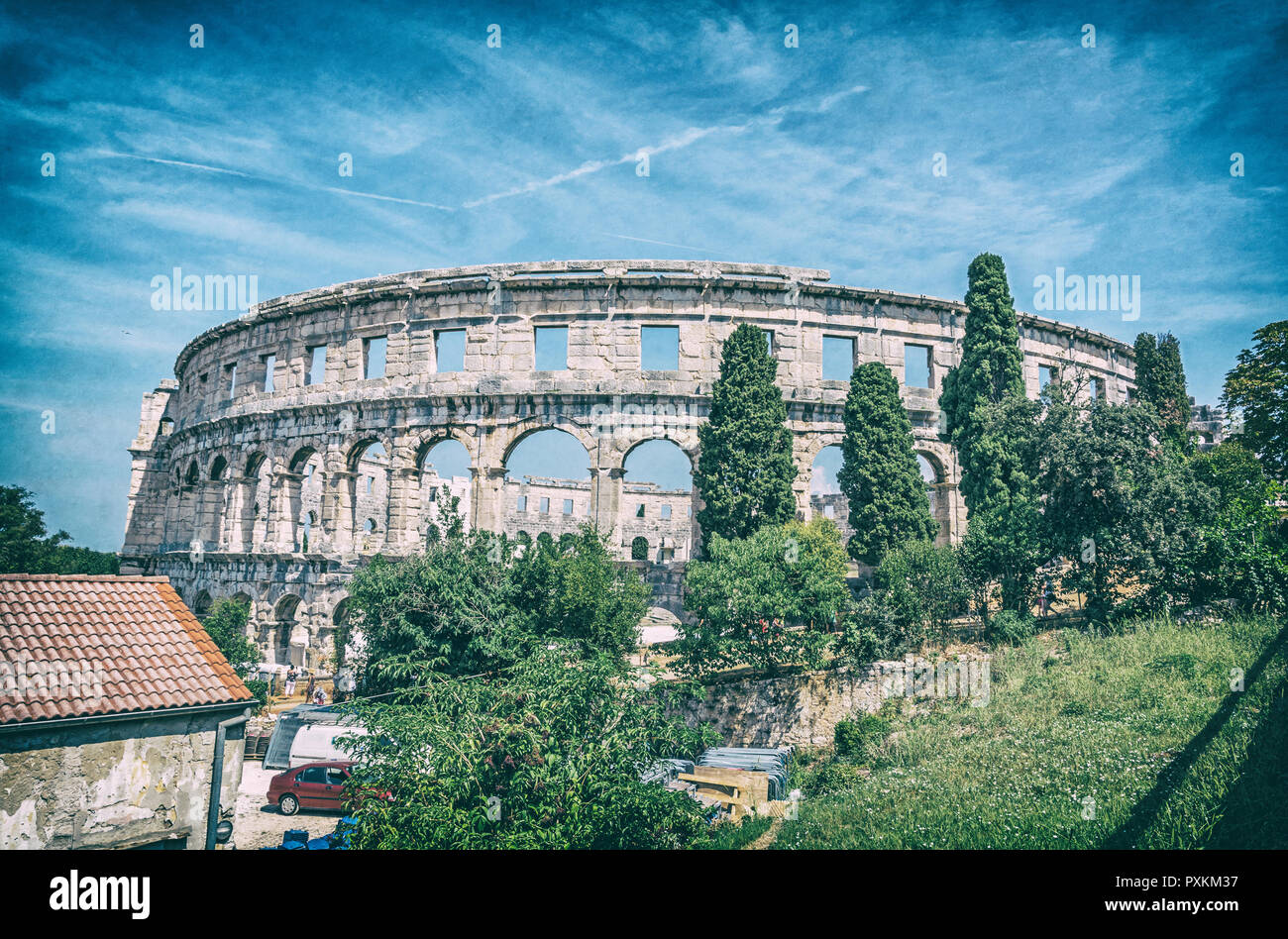 Ancient amphitheater located in Pula, Istria, Croatia. Travel destination. Famous object. Analog photo filter with scratches. Stock Photo