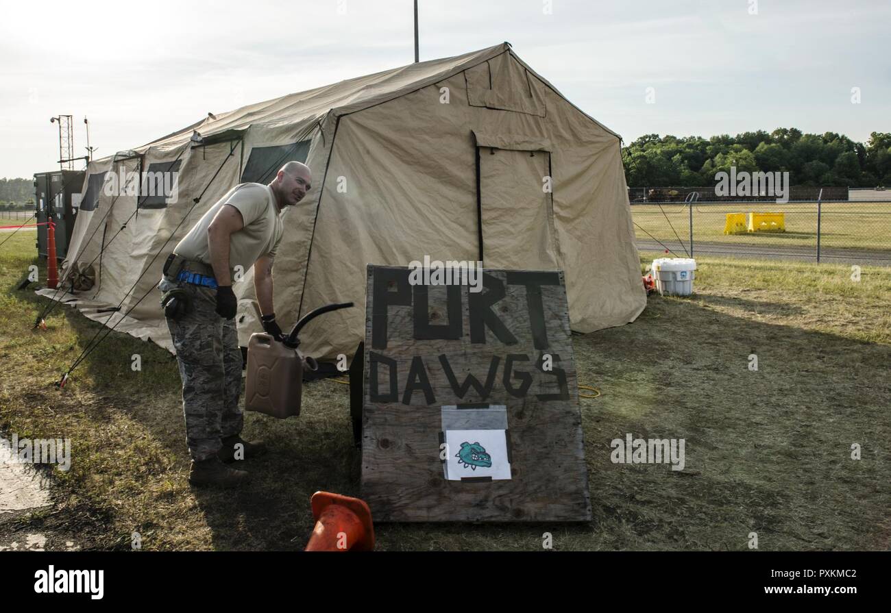 U.S. Air Force Tech. Sgt. Jason Green, 821st Contingency Response Squadron, air transportation, prepares to put gasl into a tent generator during a medical exercise at Battle Creek Air National Guard Base, Michigan, on June 11, 2017. Turbo Distribution 17-2 is a U.S. Transportation Command exercise designed to assess the Joint Task Force-Port Opening’s ability to deliver and distribute cargo during humanitarian and disaster relief operations. Stock Photo