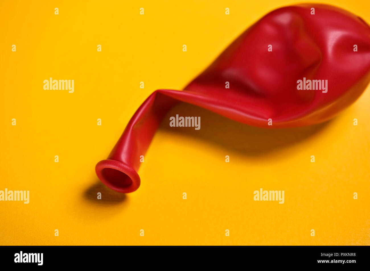 A red balloon on a yellow background Stock Photo