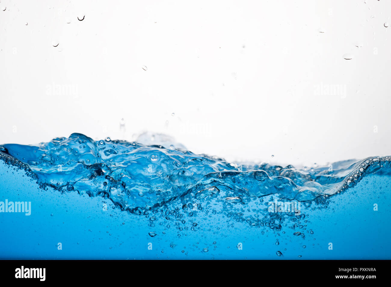 Waves of clear blue water and bubbles Stock Photo