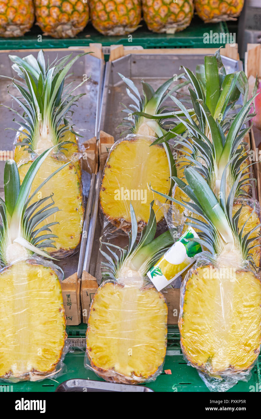 Packed halved pineapples for sale at a market stall in Germany Stock