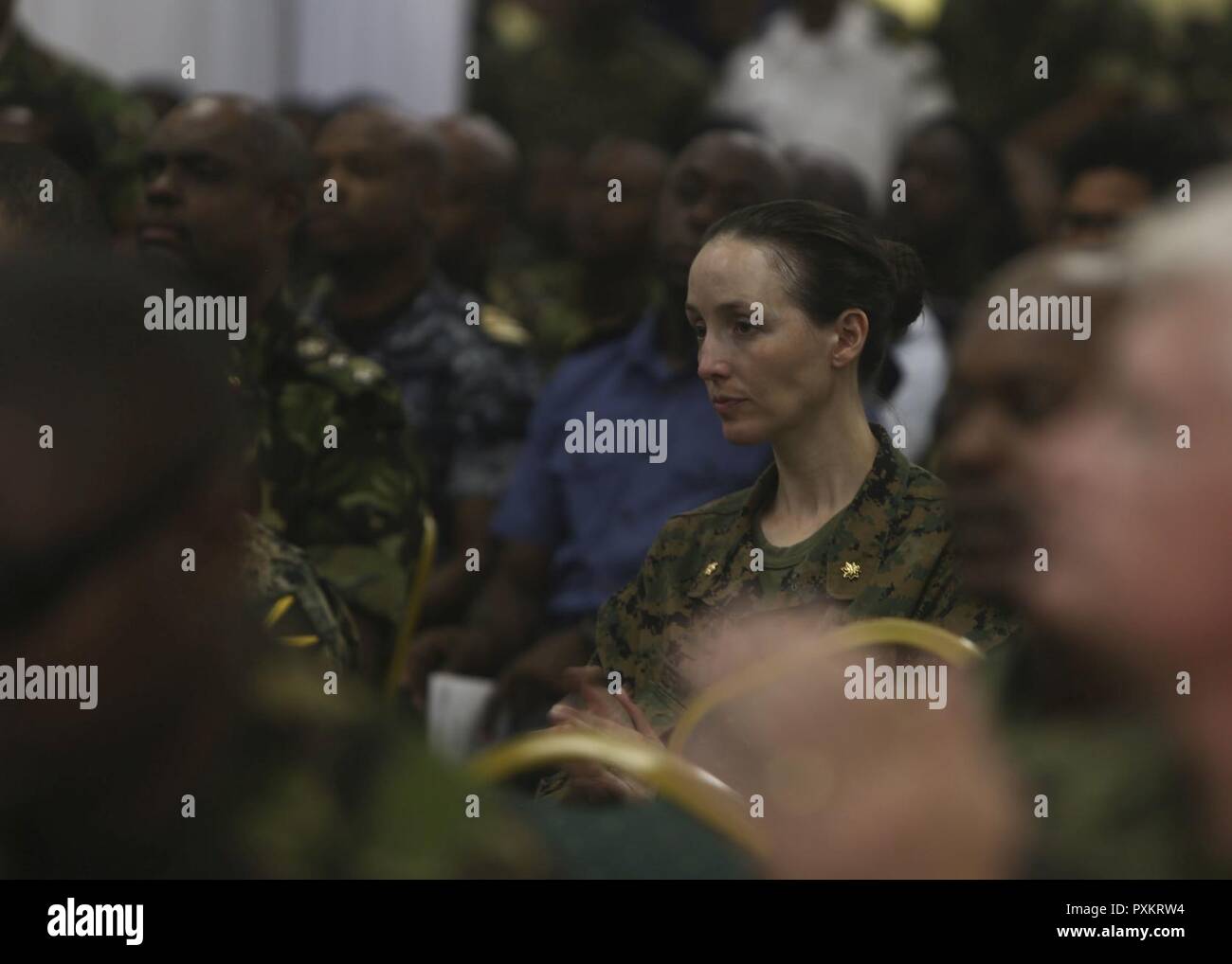 U.S. Marine Maj. Bethany Peterson, Combat Logistics Battalion 23 detachment officer in charge, claps after a speech during the closing ceremony for Phase II of Tradewinds 2017 in Chaguaramas, Trinidad and Tobago, June 17, 2017. This annual exercise, sponsored by U.S. Southern Command, is designed to increase the interoperability of the 20 nations involved and their ability to counter transnational organized crime and terrorism, and conduct humanitarian assistance and disaster relief operations. U.S. Marines provided training and logistical support for Phase II of Tradewinds. Stock Photo