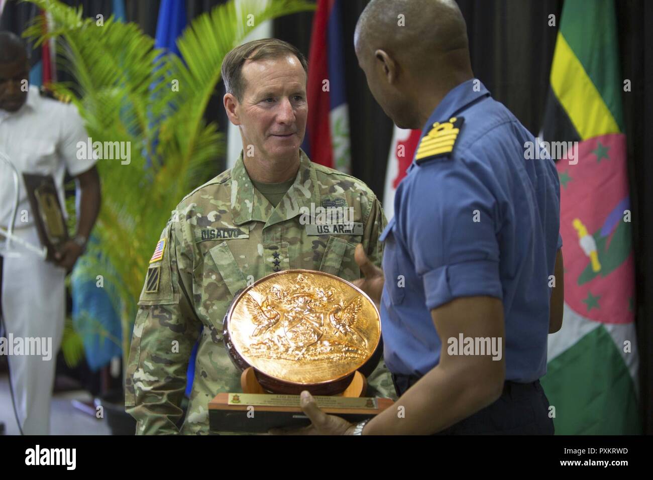 Trinidad and Tobago Defence Force Capt. Hayden Pritchard, right, the chief of Defence Staff for Trinidad and Tobago Defence Force, presents U.S. Army Lt. Gen. Joseph P. Disalvo, the military deputy commander of U.S. Southern Command, with a plaque as a token of appreciation during the closing ceremony of Exercise Tradewinds 2017 Phase II in Chaguaramas, Trinidad and Tobago, June 17, 2017. This annual exercise, sponsored by SOUTHCOM, is conducted to increase the interoperability of the 20 nations involved and their ability to counter transnational organized crime and terrorism, and conduct huma Stock Photo