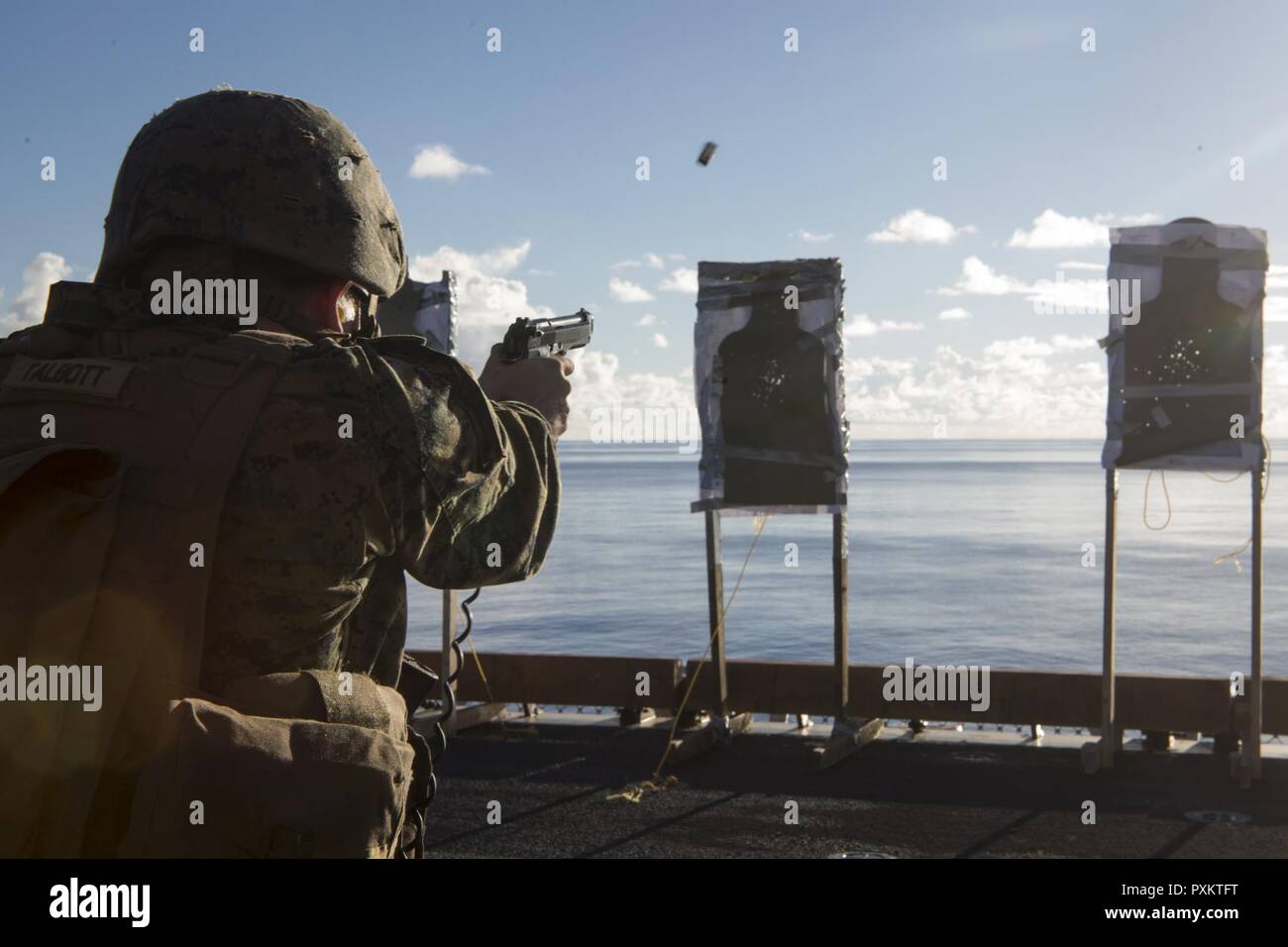Lance Cpl. Evan Talbott, a military policeman with Combat Logistics Battalion 31, fires an M9A1 9mm service pistol during marksmanship training aboard the USS Bonhomme Richard (LHD 6), June 15, 2017. CLB-31 is permanently assigned to the 31st MEU and provides support for all elements of the MEU. The 31st MEU partners with the Navy’s Amphibious Squadron 11 to form the amphibious component of the Bonhomme Richard Expeditionary Strike Group. The 31st MEU and PHIBRON 11 combine to provide a cohesive blue-green team capable of accomplishing a variety of missions across the Indo-Asia-Pacific region. Stock Photo