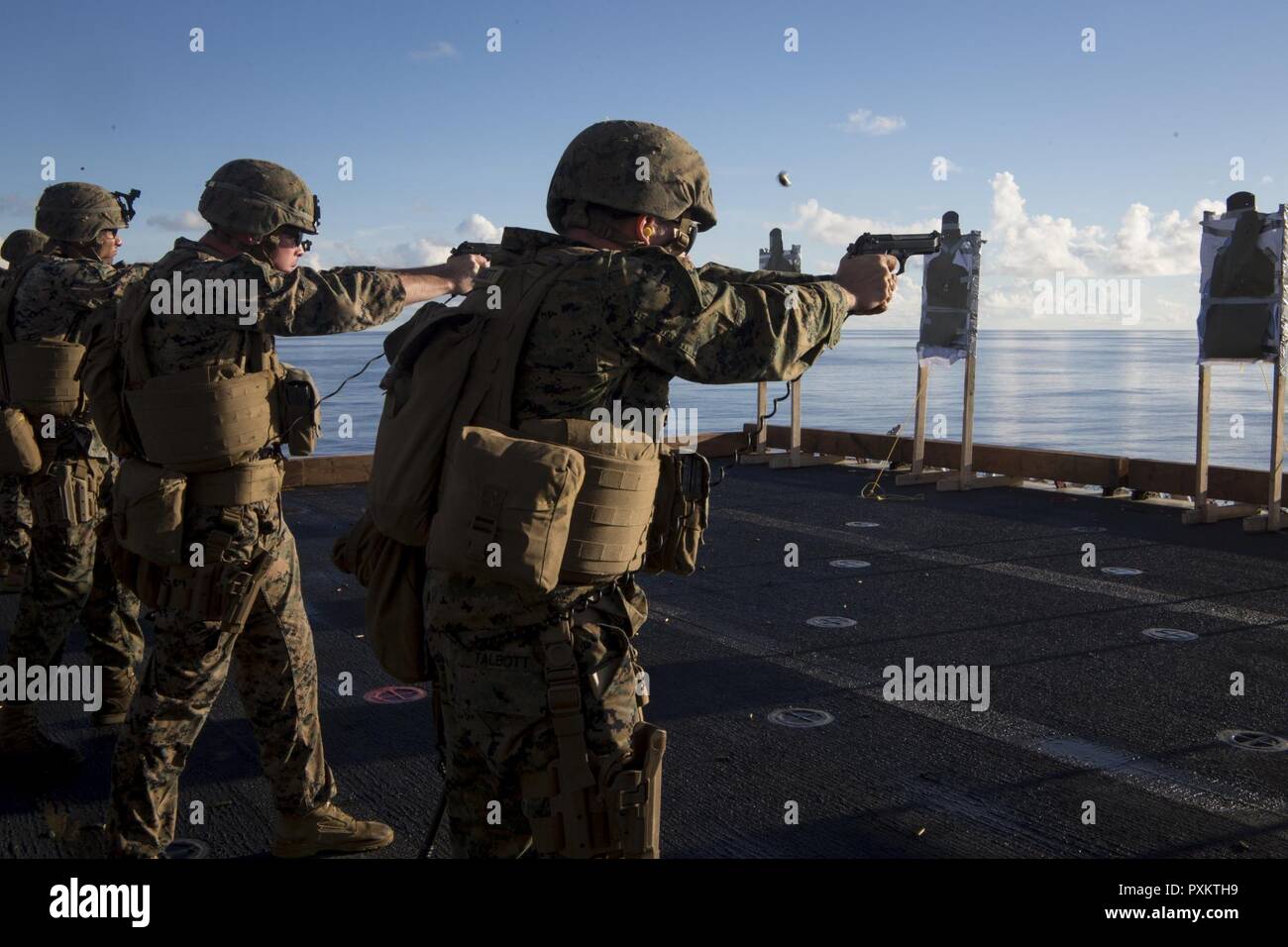 Marines with Combat Logistics Battalion 31 fire M1911 .45-caliber pistols during marksmanship training aboard the USS Bonhomme Richard (LHD 6), June 15, 2017. CLB-31 is permanently assigned to the 31st MEU and provides support for all elements of the MEU. The 31st MEU partners with the Navy’s Amphibious Squadron 11 to form the amphibious component of the Bonhomme Richard Expeditionary Strike Group. The 31st MEU and PHIBRON 11 combine to provide a cohesive blue-green team capable of accomplishing a variety of missions across the Indo-Asia-Pacific region. Stock Photo