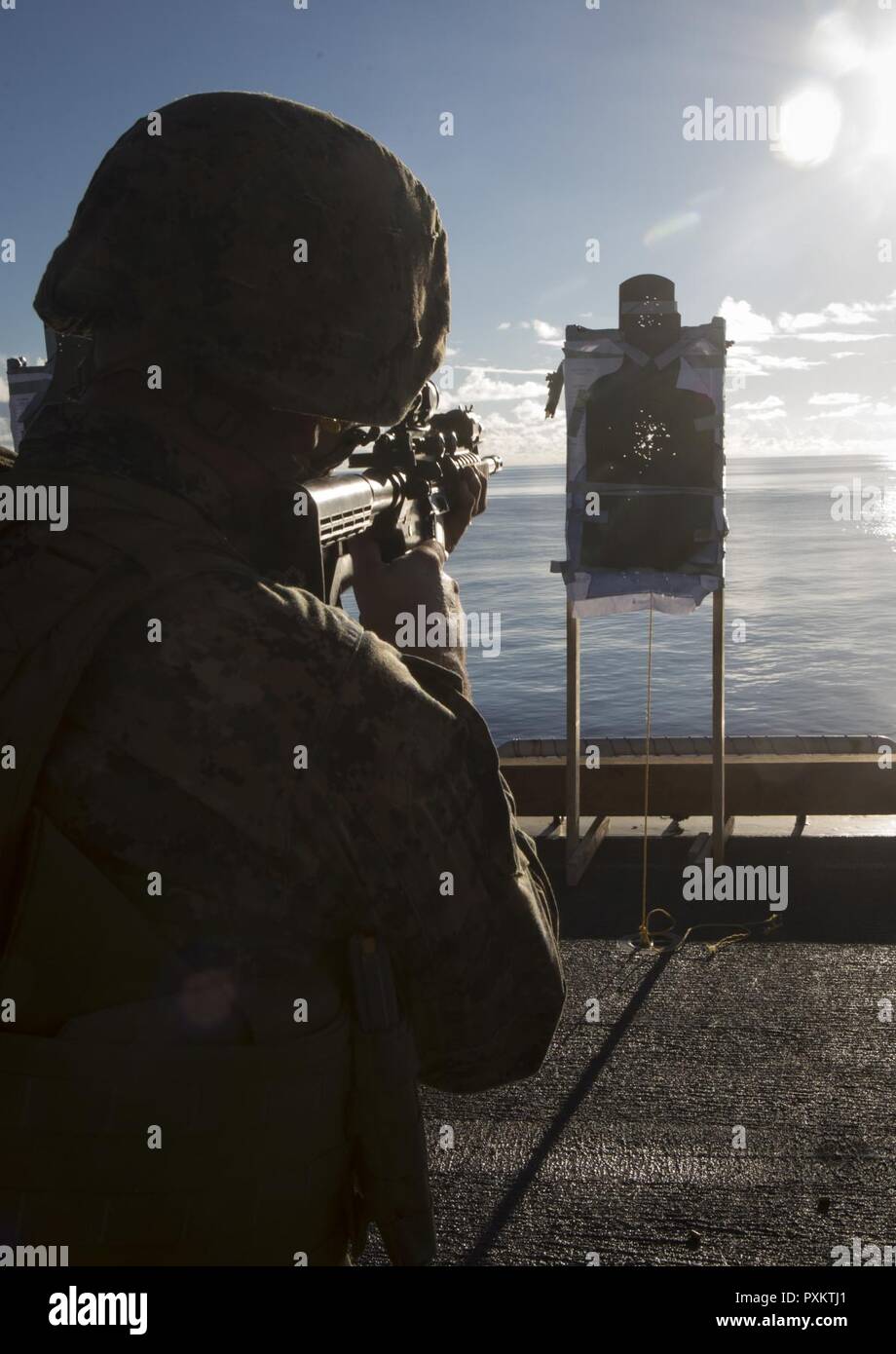 Lance Cpl. Will Bunch, a military policeman with Combat Logistics Battalion 31, fires an M4 carbine during marksmanship training aboard the USS Bonhomme Richard (LHD 6), June 15, 2017. CLB-31 is permanently assigned to the 31st MEU and provides support for all elements of the MEU. The 31st MEU partners with the Navy’s Amphibious Squadron 11 to form the amphibious component of the Bonhomme Richard Expeditionary Strike Group. The 31st MEU and PHIBRON 11 combine to provide a cohesive blue-green team capable of accomplishing a variety of missions across the Indo-Asia-Pacific region. Stock Photo