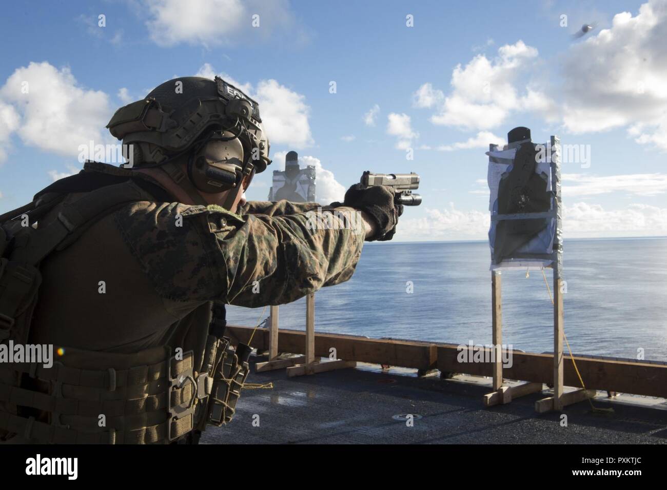Staff Sgt. Cody Fazio, a reconnaissance Marine with the 31st Marine Expeditionary Unit's Force Reconnaissance Platoon (FRP), fires an M1911 .45-caliber pistol during marksmanship training aboard the USS Bonhomme Richard (LHD 6), June 15, 2017. FRP and the Amphibious Reconnaissance Platoon form the 31st MEU's Maritime Raid Force, which specializes in reconnaissance operations from the sea. The 31st MEU partners with the Navy’s Amphibious Squadron 11 to form the amphibious component of the Bonhomme Richard Expeditionary Strike Group. The 31st MEU and PHIBRON 11 combine to provide a cohesive blue Stock Photo