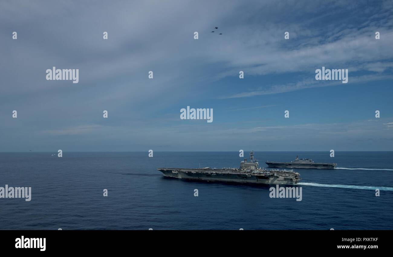 3 SOUTH CHINA SEA (June 15, 2017) F/A-18 Super Hornets from Carrier Air Wing (CVW) 5 conduct flight operations as the Nimitz-class aircraft carrier, USS Ronald Reagan (CVN 76), and Izumo-class helicopter destroyer, JS Izumo (DDH 183), steam alongside during a combined Japan Maritime Self-Defense Force (JMSDF) and U.S. Navy exercise June 13-15, 2017. Participants included USS Ronald Reagan, the Ticonderoga-class guided-missile cruiser USS Shiloh (CG 67), Carrier Air Wing 5, Destroyer Squadron 15, the Arleigh Burke-class guided-missile destroyers USS Barry (DDG 52) and USS McCampbell (DDG 85), J Stock Photo