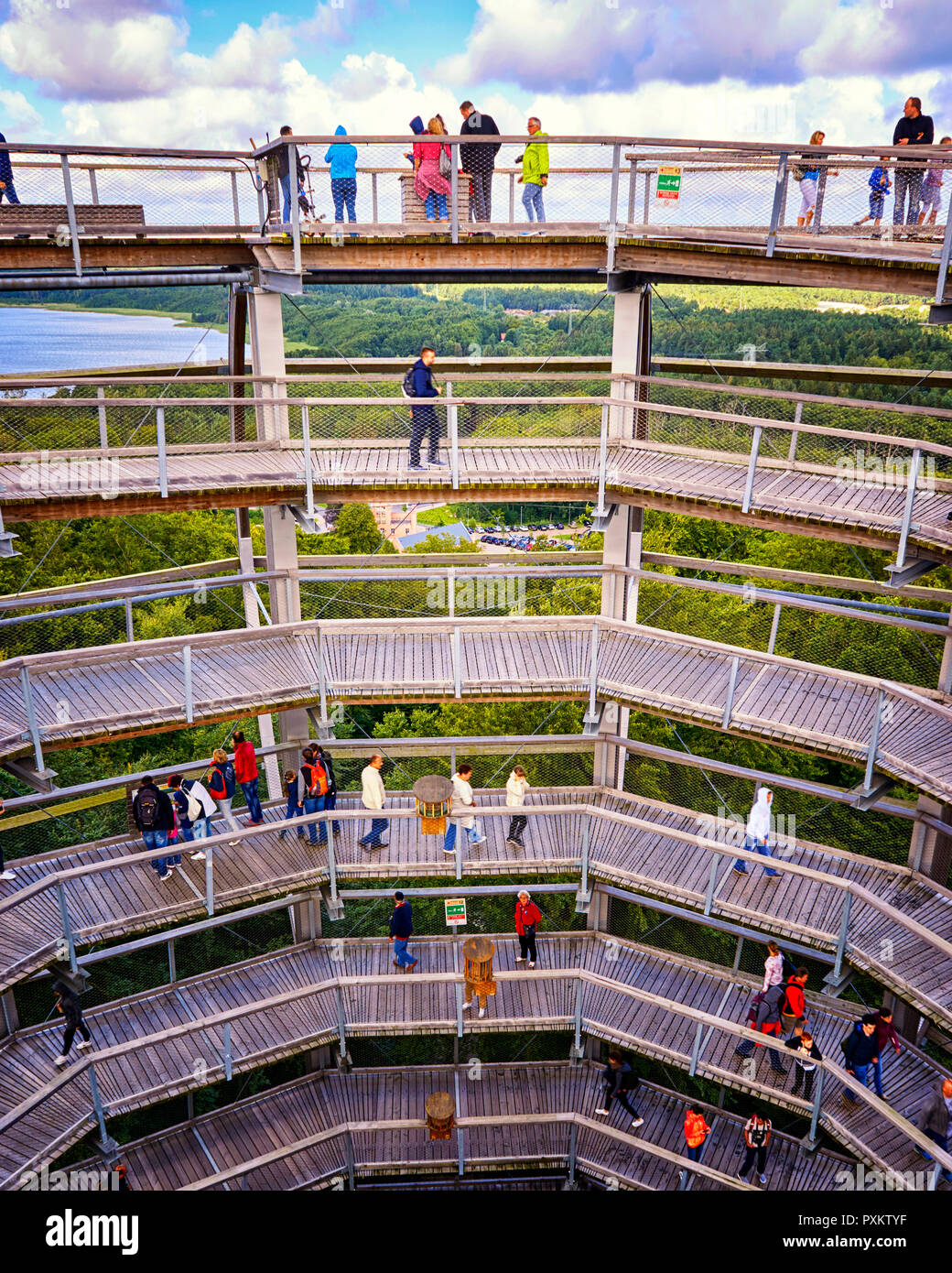 Treetop walkstorm on the island of Rügen, Germany - The tourists who walk inside the Treetop Tower experience the boundless forest wilderness with a v Stock Photo