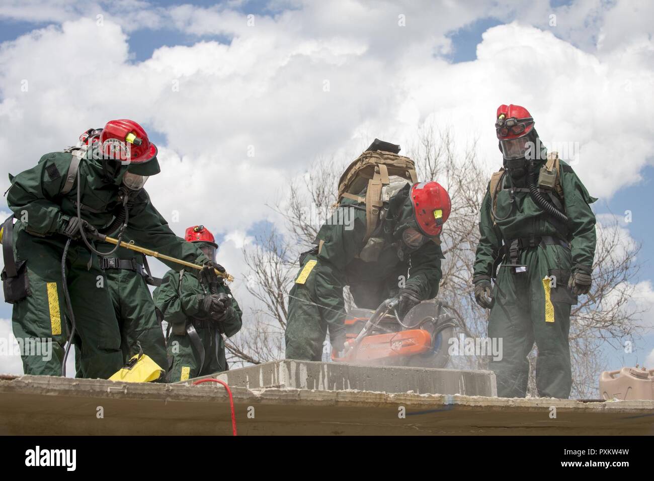Colorado National Guard Airman of the Fatality Search and Rescue Team, practice cutting through concrete for a simulated collapsed structure exercise in Lakewood, Colo., June 3, 2017. The CONG Chemical, Biological, Radiological and Nuclear Enhanced Response Force Package team of more than 100 CONG Soldiers/Airman, First Responders, evaluators, and role-players, in conjunction with the West Metro Fire District, participated in this major emergency response exercise involving simulated exposure to contaminated environments, collapsed structures and medical triage, giving CONG members the most re Stock Photo