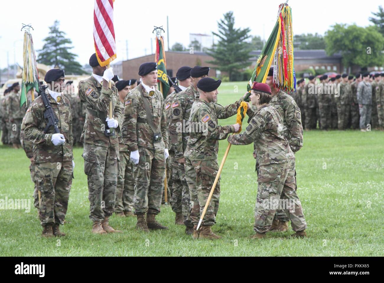 Col. Eugenia Guilmartin, commander of the 16th Military Police Brigade, hands Lt. Col. S. Joel Schuldt, commander of the 716th MP Battalion assigned to the 16th MP Bde. and attached to the 101st Airborne Division (Air Assault) Sustainment Brigade, 101st Abn. Div., the battalion colors during the change of command ceremony, June 15, 2017, at the division parade field on Fort Campbell, Kentucky. Stock Photo