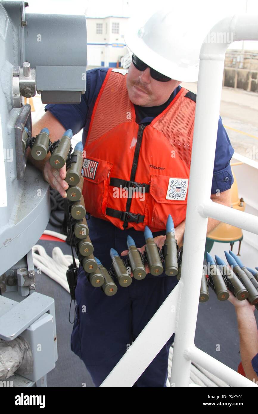 U.S. Coast Guard Culinary Specialist 1st Class Jason Estep, Cutter Winslow Griesser, helps load the M242 Bushmaster during Exercise Tradewinds 2017, at the Barbados Coast Guard Station in Barbados, June 6, 2017. Military personnel and civilians from 20 countries are participating in this year’s exercise in Barbados and Trinidad & Tobago, June 6-17. Stock Photo