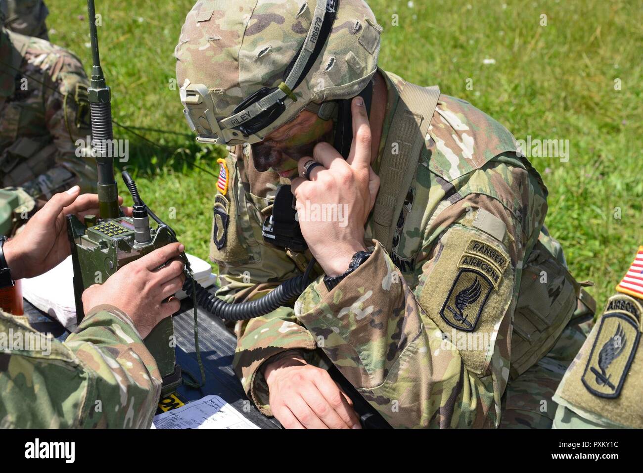 U.S. Army Paratrooper, assigned to the 2nd Battalion, 503rd Infantry Regiment, 173rd Airborne Brigade, conducts a radio check during airborne operations at Juliet Drop Zone in Pordenone, Italy, June 8, 2017. The 173rd Airborne Brigade is the U.S. Army Contingency Response Force in Europe, capable of projecting ready forces anywhere in the U.S. European, Africa or Central Commands areas of responsibility within 18 hours. Stock Photo