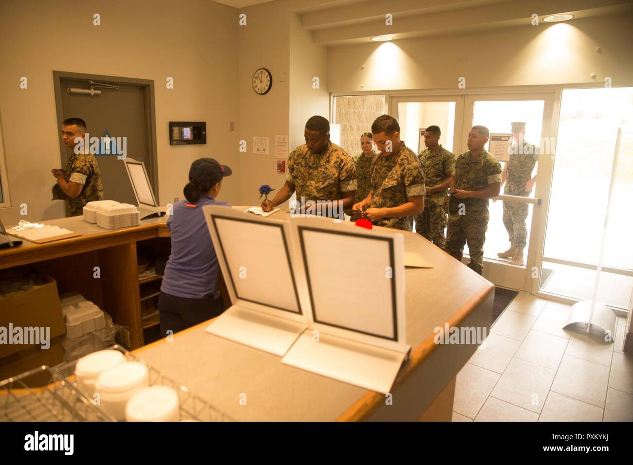U.S. Marines with 1st Marine Logistics Group sign in at the 14 area