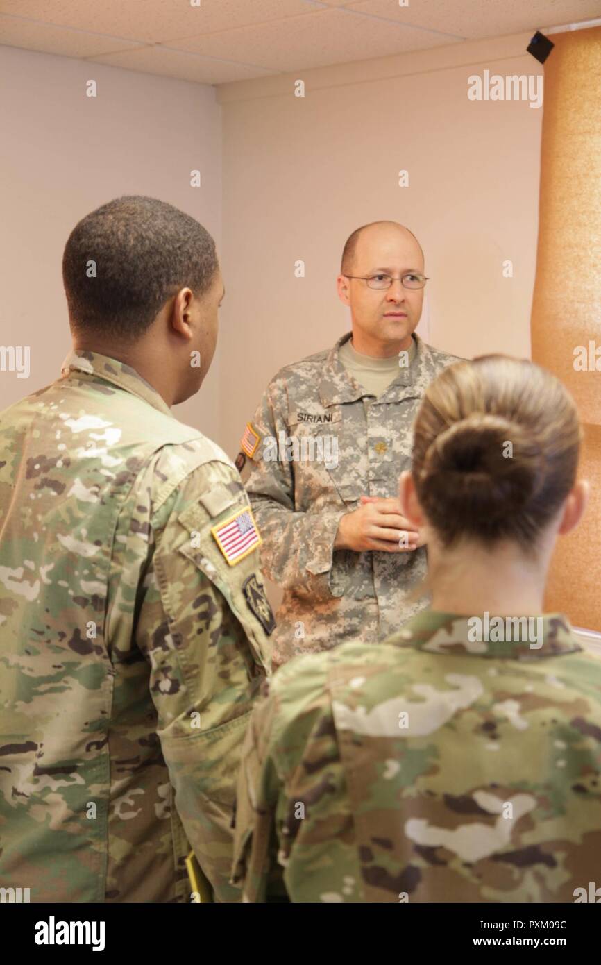Maj. Michael Siriani, acting executive officer of the 213th Regional Support Group, Pennsylvania Army National Guard, instructs the staff on the course of action analysis section of the military decision making process during the unit's annual training at Fort Indiantown Gap June 9, 2017. Stock Photo