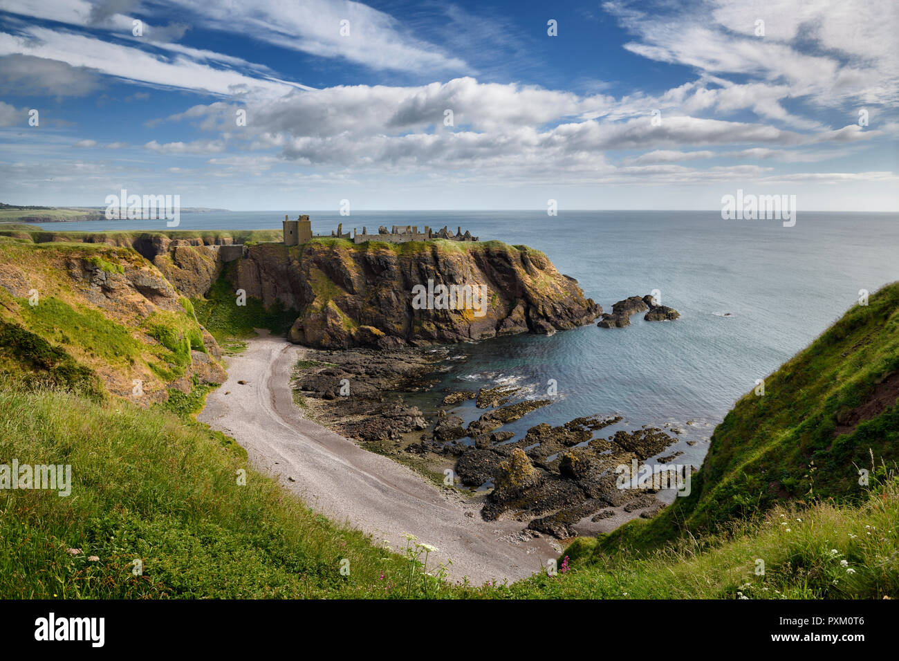 Pebble beach at Old Hall Bay North Sea from clifftop south of Donnottar Castle Medieval fortress ruins near Stonehaven Scotland UK Stock Photo