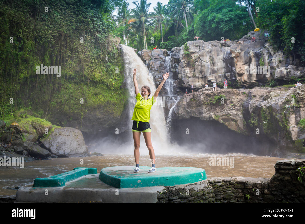 Girl In Front Of A Waterfall Stock Photo - Alamy