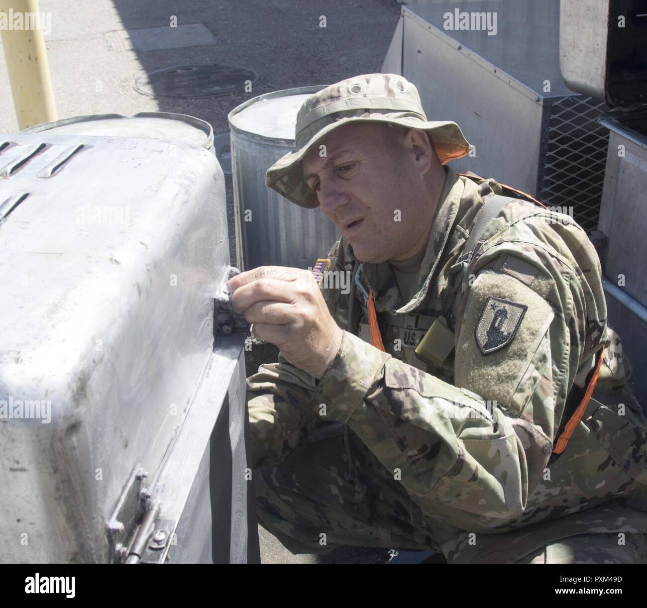 Sgt. Eric R. Collazo, a culinary specialist with the 1473rd Quartermaster Company, Puerto Rico Army National Guard, cleans cooking equipment after serving breakfast June 12, 2017, during Mississippi's 155th Armored Brigade Combat Team’s rotation at the National Training Center. The 1473rd is one of 40 units supporting the 155th during training at NTC. (Mississippi Stock Photo