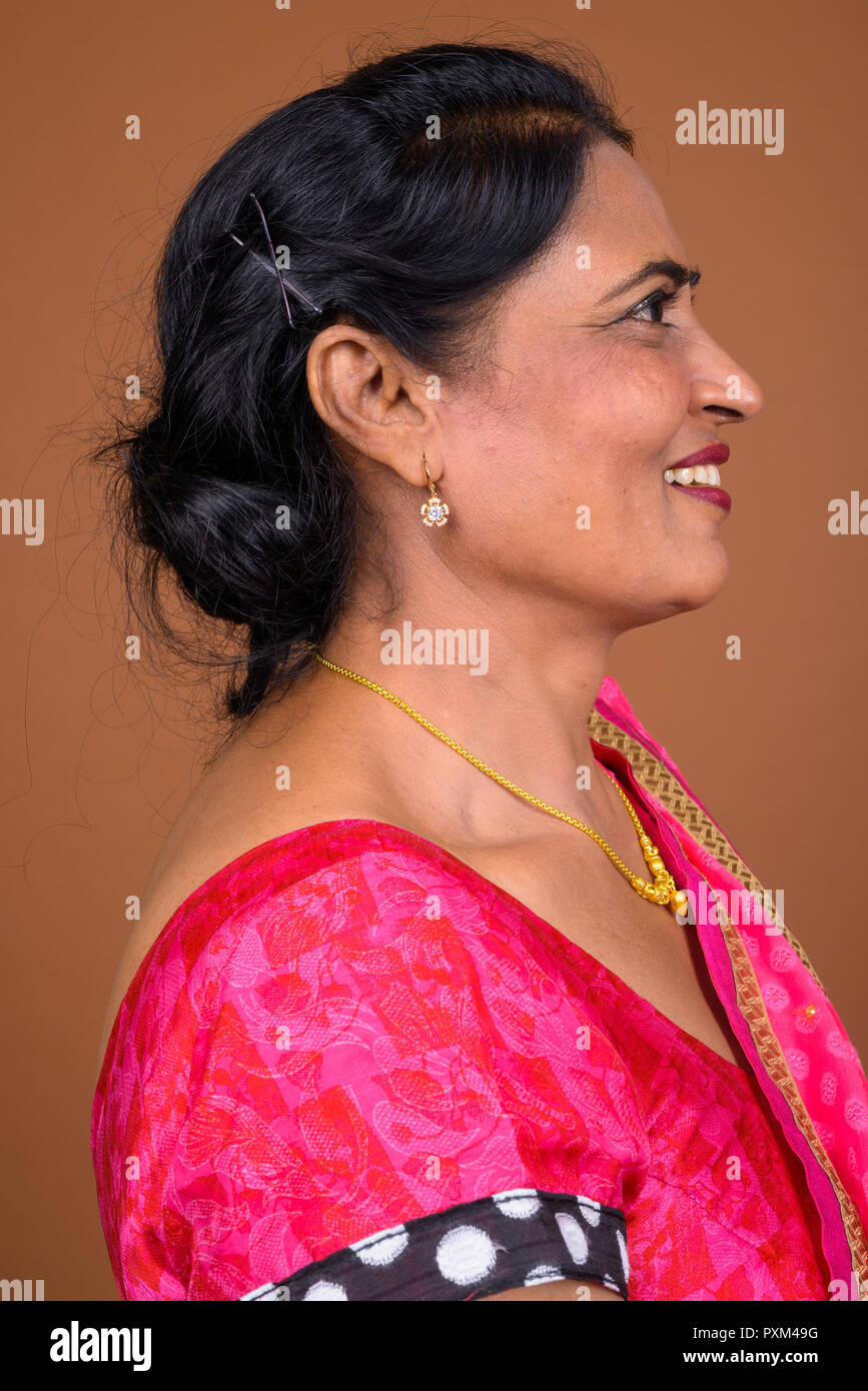 Profile view of happy Indian woman smiling Stock Photo