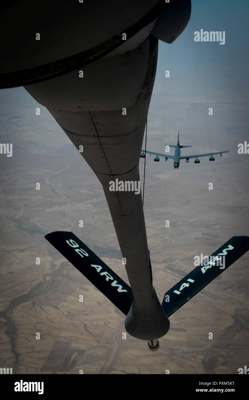 A U.S. Air Force B-52 Stratofortress receives fuel from a 340th Expeditionary Air Refueling Squadron KC-135 Stratotanker during a flight in support of Operation Inherent Resolve June 9, 2017. Despite being in the Air Force inventory for more than 50 years, B-52s can drop precision-guided weapons. The aircraft's payload capacity of 70,000 pounds can include gravity bombs, cluster bombs, precision-guided missiles and Joint Direct Attack Munitions. Stock Photo