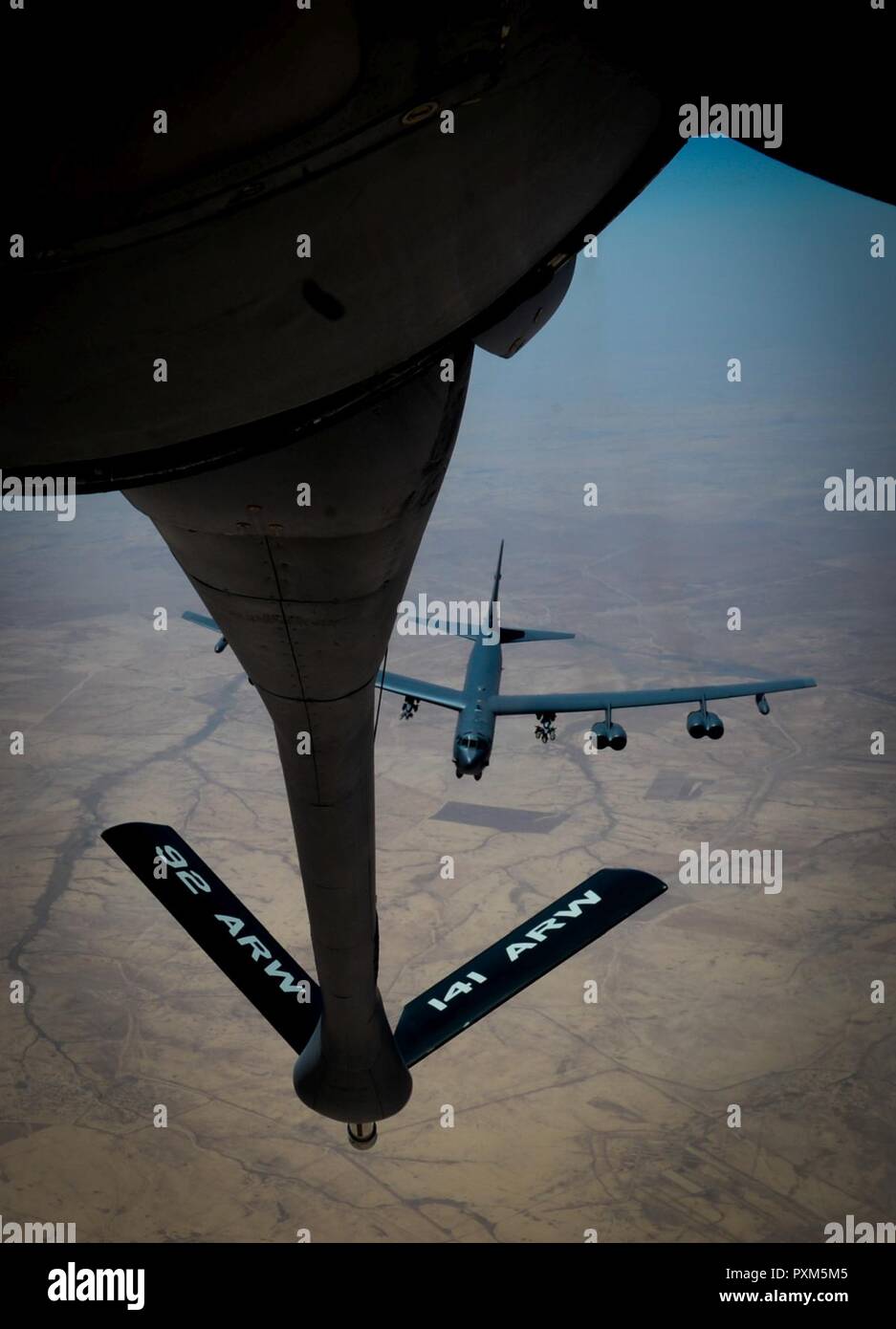 A U.S. Air Force B-52 Stratofortress departs after receiving fuel from a 340th Expeditionary Air Refueling Squadron KC-135 Stratotanker during a flight in support of Operation Inherent Resolve June 9, 2017. Despite being in the Air Force inventory for more than 50 years, B-52s can drop precision-guided weapons. The aircraft's payload capacity of 70,000 pounds can include gravity bombs, cluster bombs, precision-guided missiles and Joint Direct Attack Munitions. Stock Photo