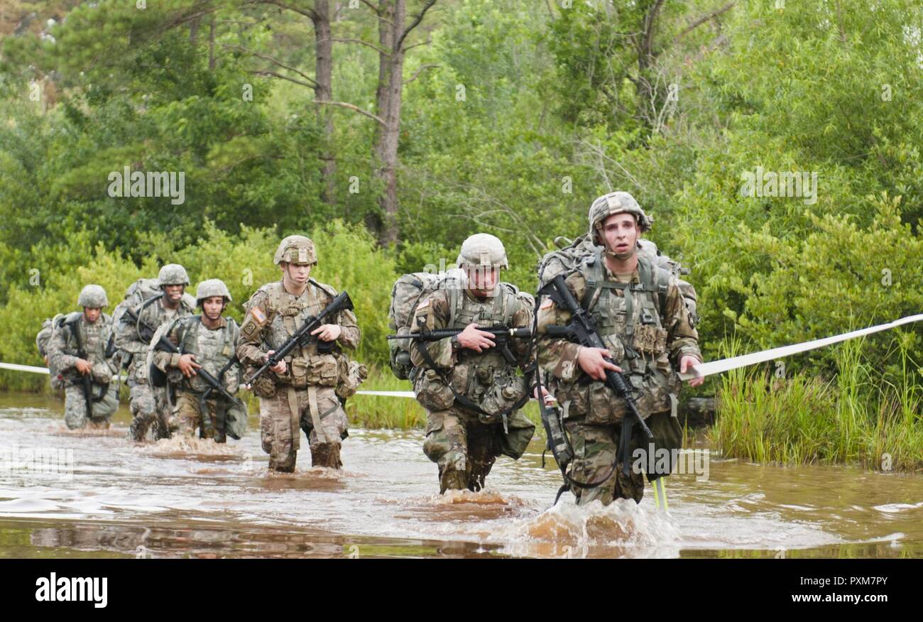 Army Reserve Soldiers Cross A Water Obstacle At The End Of An