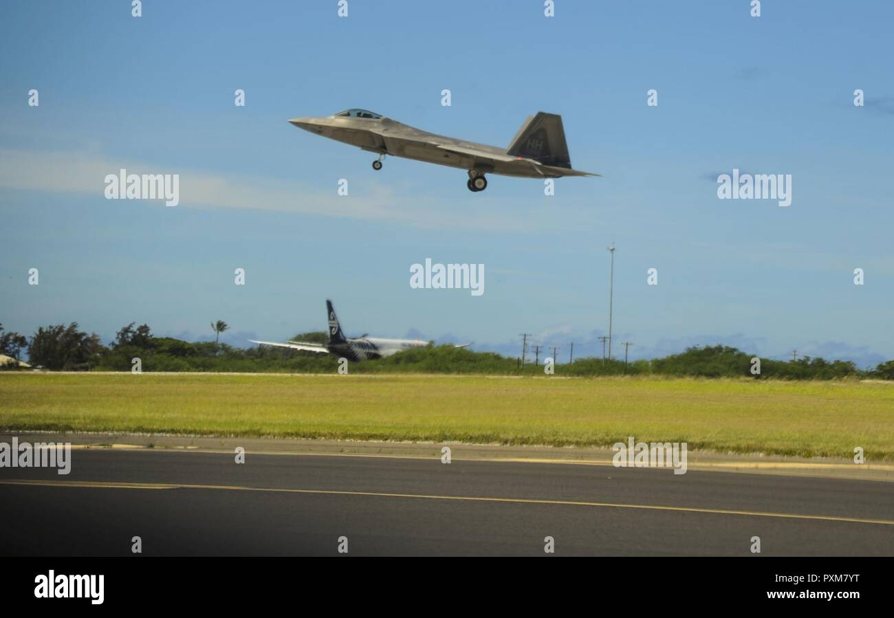 An F-22 Raptor, assigned to the 199th Fighter Squadron, lands on Joint Base Pearl Harbor-Hickam, Hawaii, June 13, 2017.   The F-22 Raptor is the Air Force’s 5th generation fighter aircraft. Its combination of stealth, supercruise, maneuverability and integrated avionics, coupled with improved supportability, represents an exponential leap in warfighting capabilities. The Raptor performs both air-to-air and air-to-ground missions allowing full realization of operational concepts vital to the 21st-century Air Force. Stock Photo