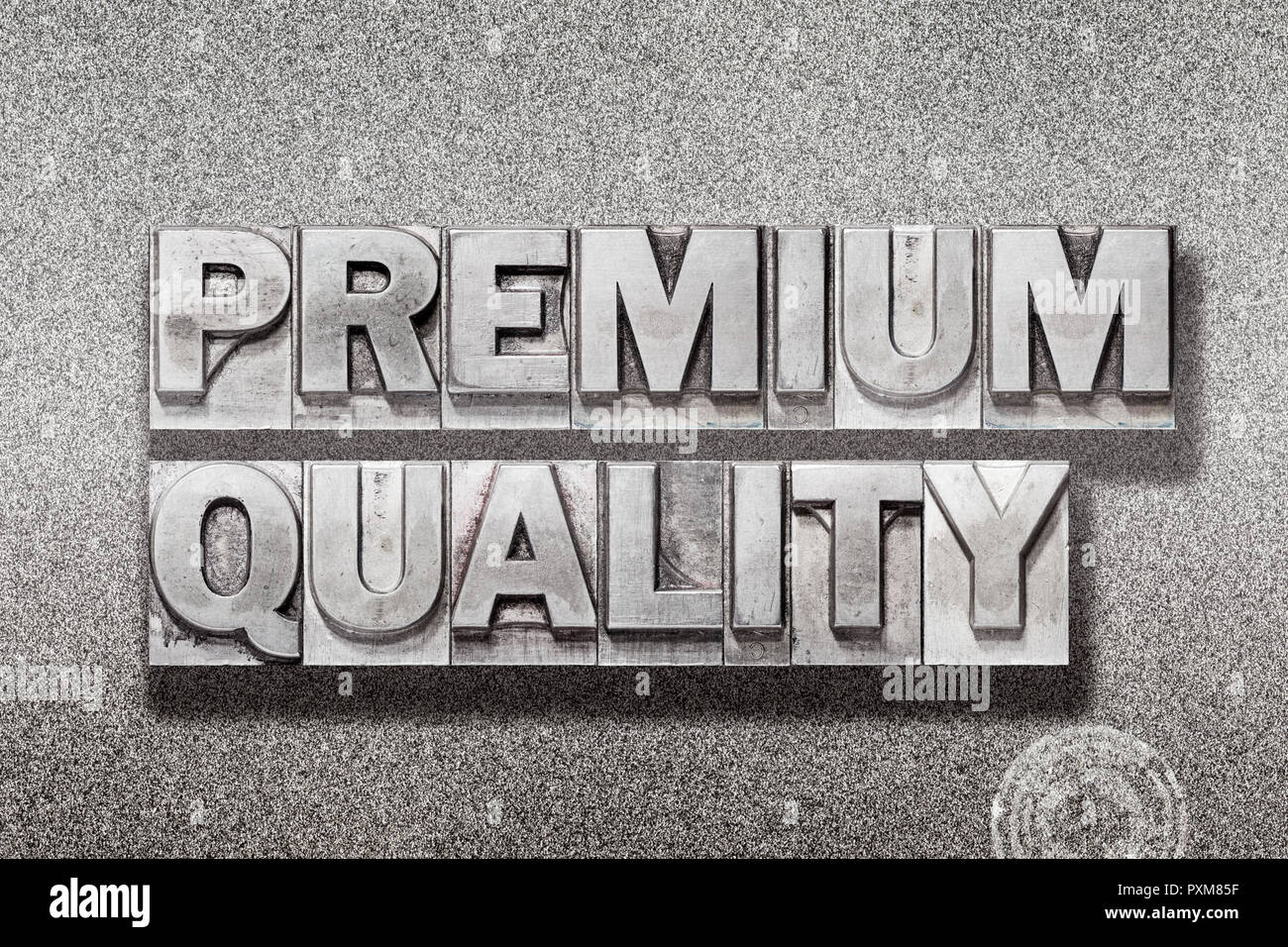 premium quality phrase made from vintage letterpress on metallic textured background Stock Photo