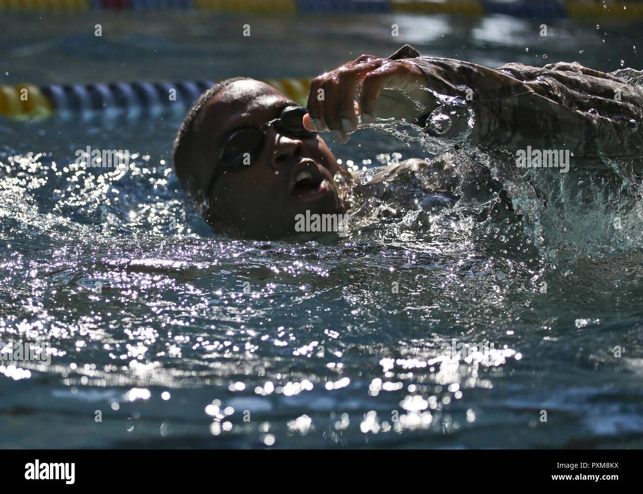 U.S. Air Force Staff Sgt. Rafiq Pickett from the New Jersey Air National Guard's 108th Security Forces Squadron swims the 100 meter challenge during a German Armed Forces Badge for Military Proficiency test at Joint Base McGuire-Dix-Lakehurst, N.J., June 13, 2017. The test included an 1x10-meter sprint, flex arm hang, 1,000 meter run, 100 meter swim in Military Uniform, marksmanship, and a timed foot march. Stock Photo