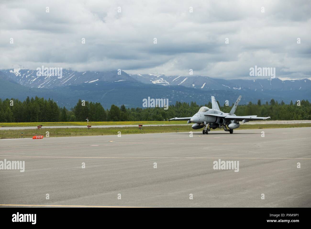 An F/A-18C Hornet assigned to Marine Fighter Attack Squadron 251 taxis on a flight line during Red Flag-Alaska 17-2 on Joint Base Elmendorf–Richardson, Alaska, June 12, 2017. Red Flag-Alaska provides an optimal training environment in the Indo-Asian Pacific region and focuses on improving ground, space, and cyberspace combat readiness and interoperability for U.S. and international forces. Stock Photo