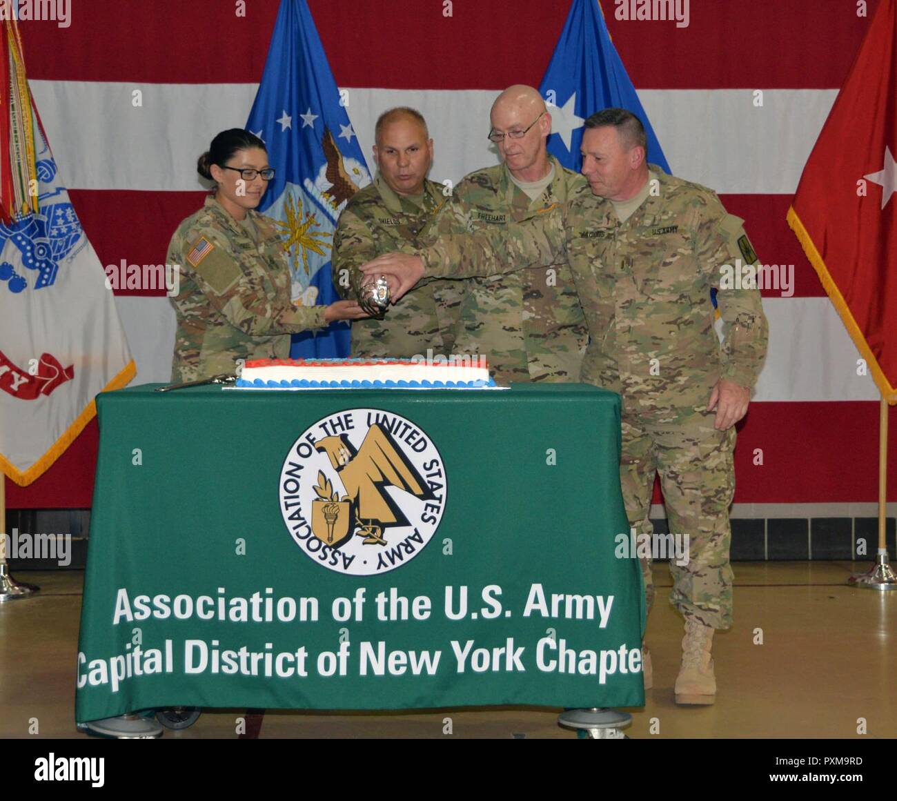 Youngest and oldest Soldiers present cut the birthday cake during Army Birthday ceremonies at New York National Guard Headquarters in Latham, N.Y. on June 17, 2017. Cutting the cake are, from left, PFC Jade Richards, the youngest Solldier, Brig. Gen. Raymond Shields, commander of the New York Army National Guard, Col. James Freehart, the oldest Soldier present, and Chief Warrant Officer 5 Gordon Jacobs, another Army veteran.New York Army National Guard members celebrated the 242nd Birthday of the United States Army. Stock Photo