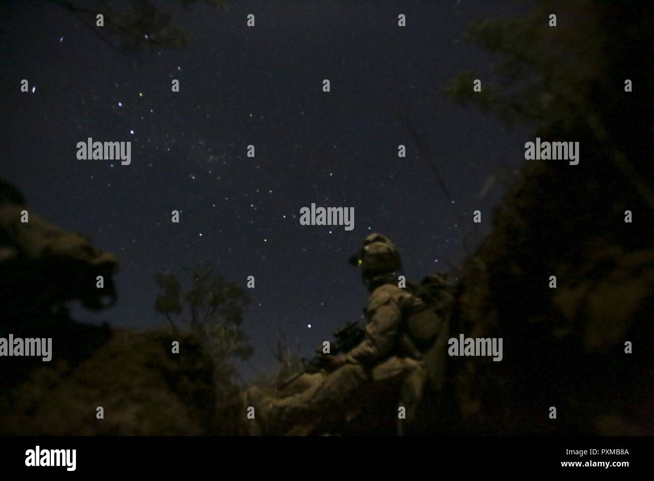 NORTHERN TERRITORY, Australia – Lance Cpl. Andrew Naranjo, rifleman,  Company L, 3rd Battalion, 4th Marine Regiment, 1st Marine Division, Marine  Rotational Force Darwin, looks up at the sky after setting up his