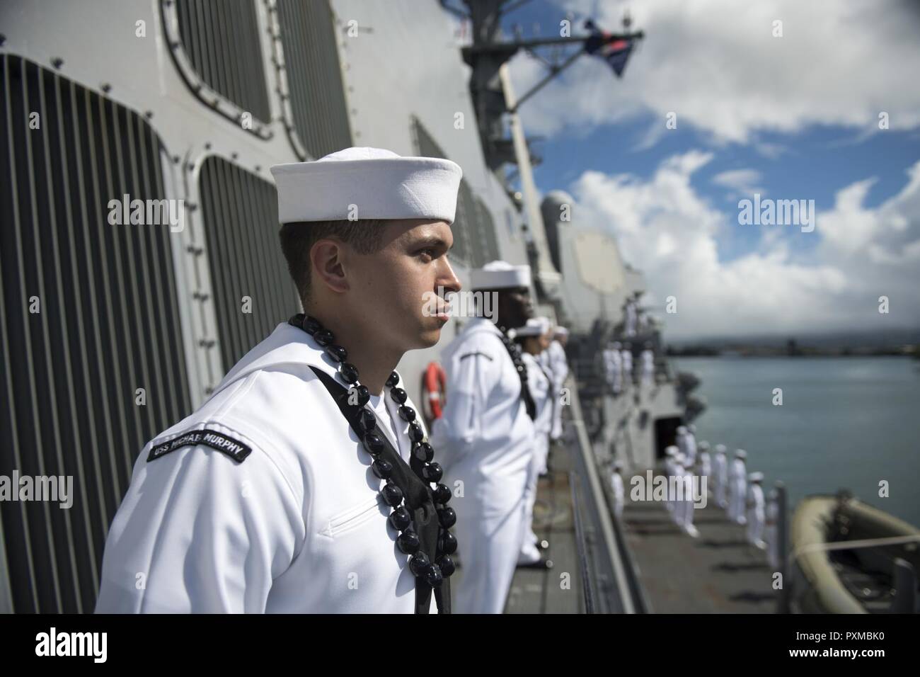 PEARL HARBOR (June 13, 2017) Machinist’s Mate 2nd Class Nick Magarelli, from Fair Lawn, New Jersey, mans the rails aboard Arleigh Burke-class guided-missile destroyer USS Michael Murphy (DDG 112) as the ship returns to its homeport Joint Base Pearl Harbor-Hickam after a 5-month deployment. Michael Murphy was on a Western Pacific deployment in the Indo-Asia-Pacific region as part of the Carl Vinson Carrier Strike Group. Stock Photo