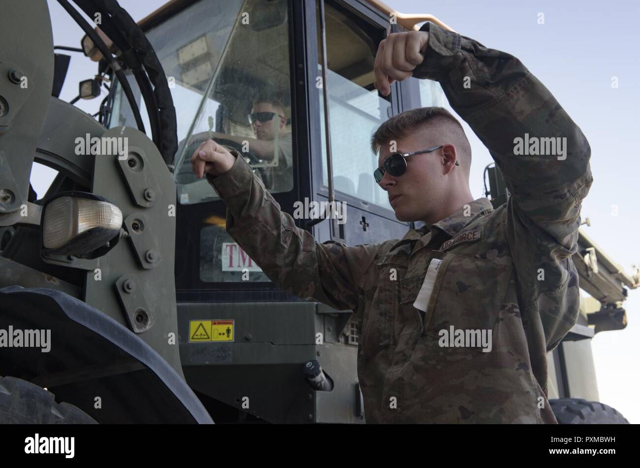 Airman 1st Class Blaine Runge directs a forklift operator, Senior Airman Giovany Tellez, both with the 455th Expeditionary Logistics Readiness Squadron traffic management office, where to unload a crate at Bagram Airfield, Afghanistan, June 13, 2017. The 455th ELRS TMO receives and processes every shipment that comes through Bagram Airfield. Stock Photo