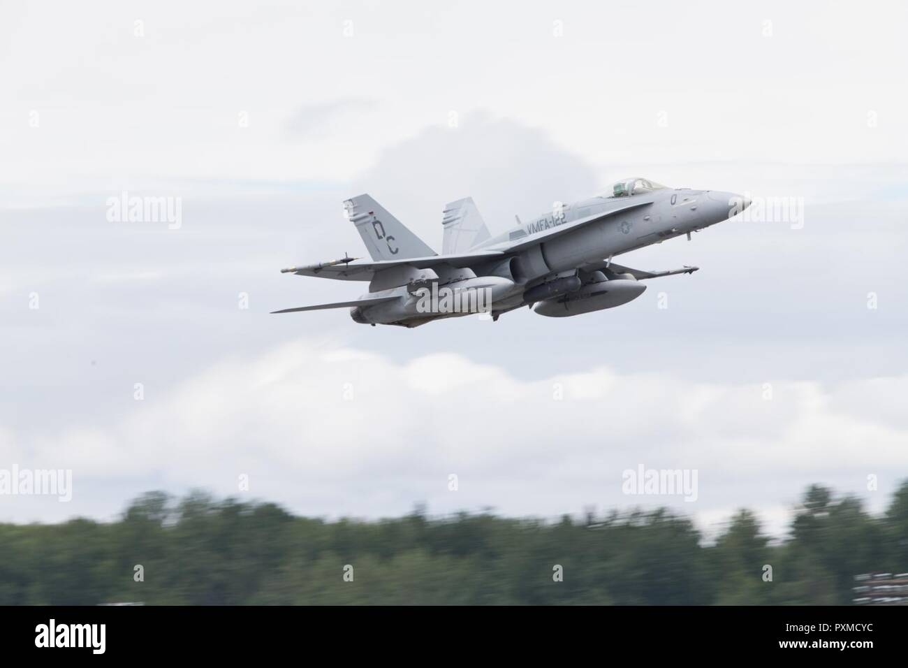 A U.S. Marine Corps F/A-18C Hornet with Marine Fighter Attack Squadron 122 takes off during Red Flag-Alaska 17-2 on Joint Base Elmendorf-Richardson, Alaska, June 13, 2017. Red Flag-Alaska provides an optimal training environment in the Indo-Asian Pacific region and focuses on improving ground, space, and cyberspace combat readiness and interoperability for U.S. and international forces. Stock Photo