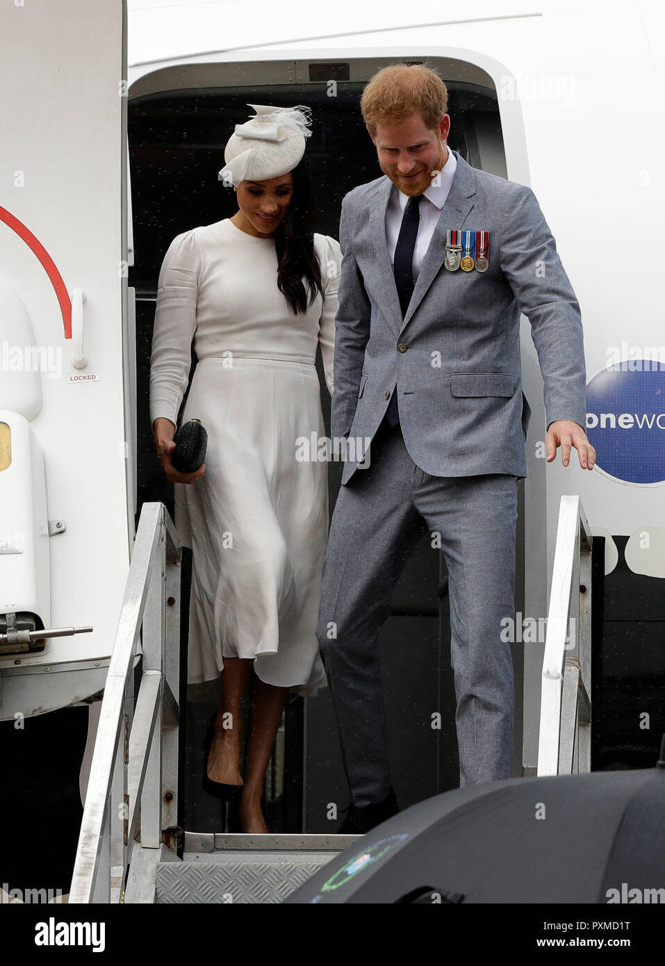 The Duke and Duchess of Sussex disembark from their plane on their arrival in Suva, on day one of the royal couple's visit to Fiji. Stock Photo