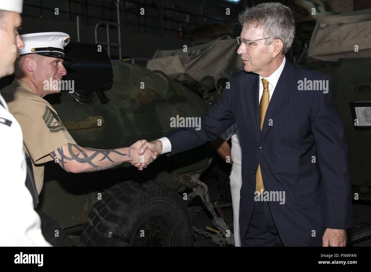 PIRAEUS, Greece (June 13, 2017) Geoffrey Pyatt, U.S. Ambassador to Greece, shakes hands with Gunnery Sgt. William Negahnquet aboard the San Antonio-class amphibious transport dock ship USS Mesa Verde (LPD 19) during a scheduled visit June 13, 2017. The ship is deployed with the Bataan Amphibious Ready Group and 24th Marine Expeditionary Unit to support maritime security operations and theater security cooperation efforts in the U.S. 6th Fleet and U.S. 5th Fleet areas of operations. Stock Photo