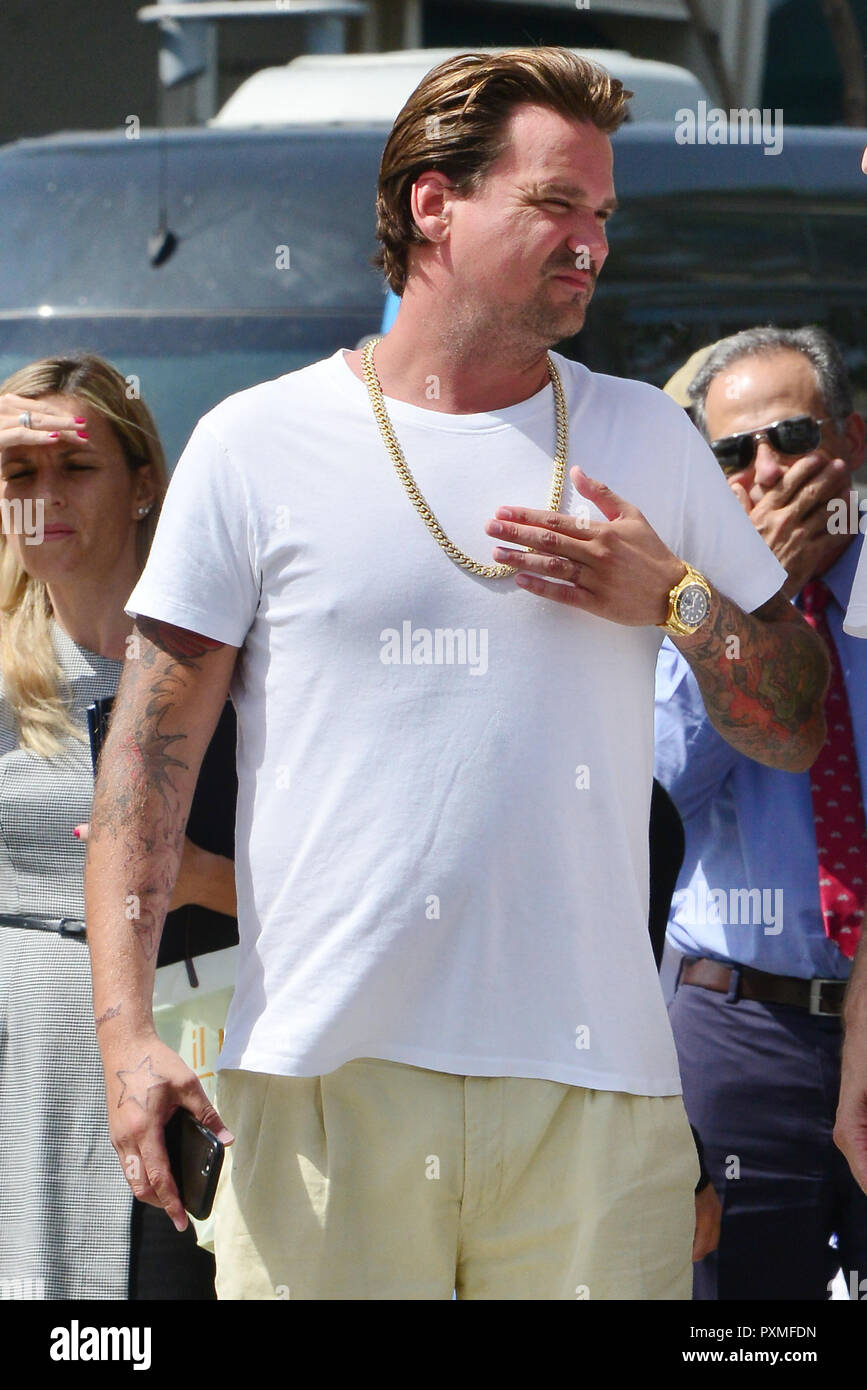 Sean Stewart out in Beverly Hills wearing a white t-shirt and a gold as as a gold Rolex watch and Nike sandals while in great spirits. Featuring: Stewart