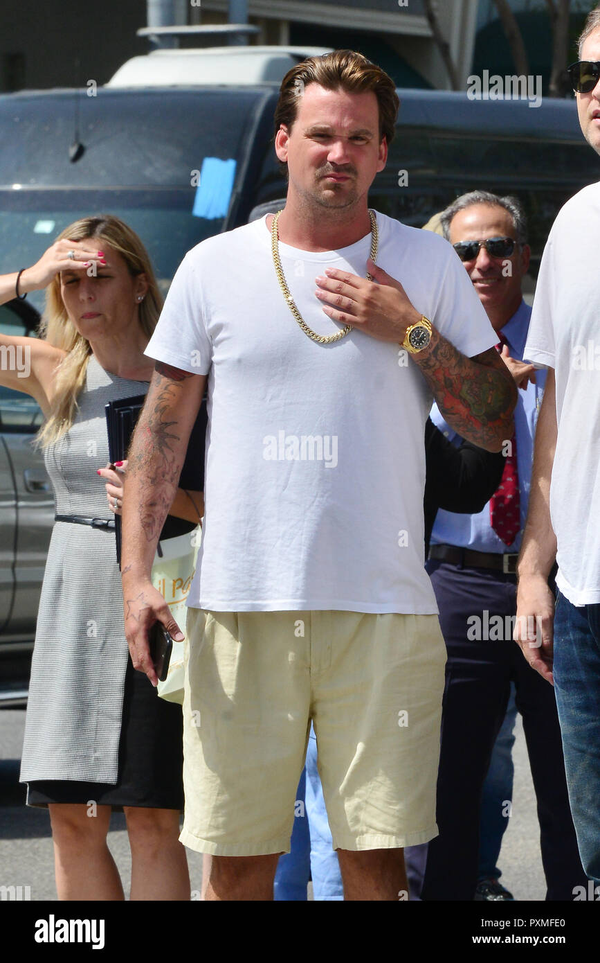 Sean Stewart out in Beverly Hills wearing a white t-shirt and a gold chain  as well as a gold Rolex watch and Nike sandals while in great spirits.  Featuring: Sean Stewart Where: